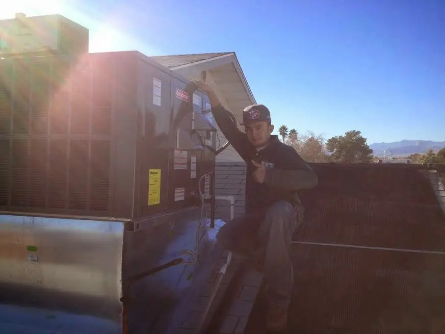 HVAC technician performing HVAC Inspection on a rooftop unit in San Marcos